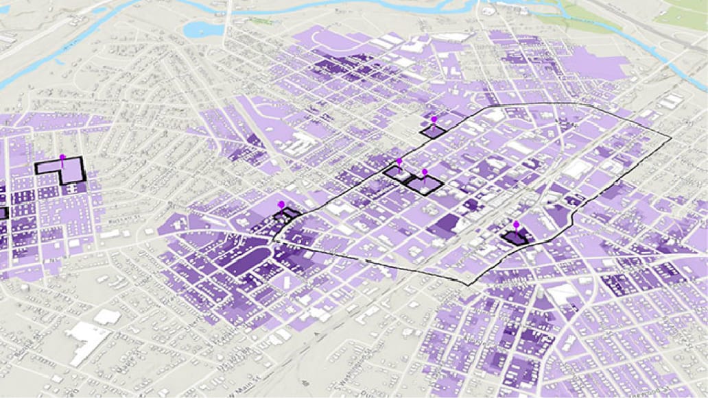 An aerial 3D map displaying an expansive area in different shades of purple with some locations pinpointed with a map marker