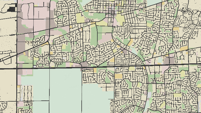 A section of a stylized city map showing streets, blocks, and land use with various colors indicating different zones.