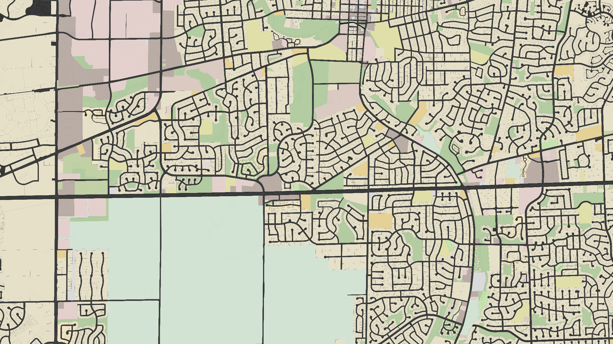 A section of a stylized city map showing streets, blocks, and land use with various colors indicating different zones.