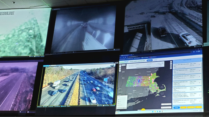  A view of the Highway Operations Center showing six monitors with a dashboard displayed on the wall.