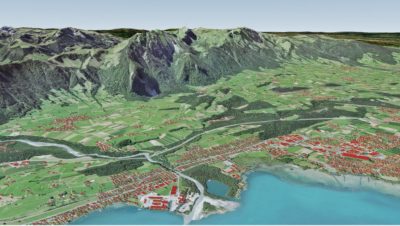 A virtual 3D landscape featuring a mountain, green land, and coastline with buildings represented as red polygons