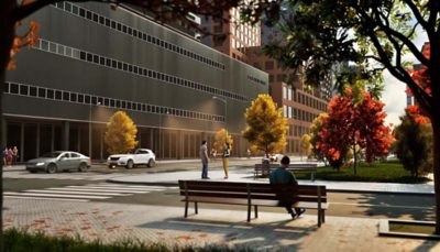 A 3D city street scene with a man sitting on a bench, cars driving by, and trees with yellow and red leaves.